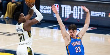 Oct 23, 2025; Indianapolis, Indiana, USA;  Indiana Pacers guard Bennedict Mathurin (00) shoots the ball while Oklahoma City Thunder forward Brooks Barnhizer (23) defends in the first half at Gainbridge Fieldhouse. Mandatory Credit: Trevor Ruszkowski-Imagn Images