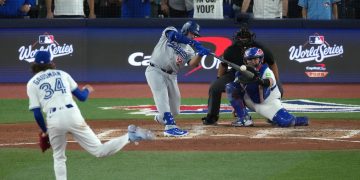 Oct 25, 2025; Toronto, Ontario, CAN; Los Angeles Dodgers third baseman Max Muncy (13) hits a solo home run against the Toronto Blue Jays in the seventh inning during game two of the 2025 MLB World Series at Rogers Centre. Mandatory Credit: Nick Turchiaro-Imagn Images