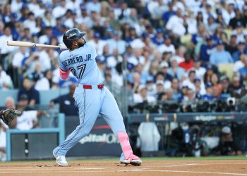 Oct 29, 2025; Los Angeles, California, USA; Toronto Blue Jays first baseman Vladimir Guerrero Jr. (27) hits a solo home run during the first inning against the Los Angeles Dodgers during game five of the 2025 MLB World Series at Dodger Stadium. Mandatory Credit: Kiyoshi Mio-Imagn Images